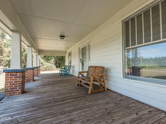 a view of a house with wooden floor and outdoor seating