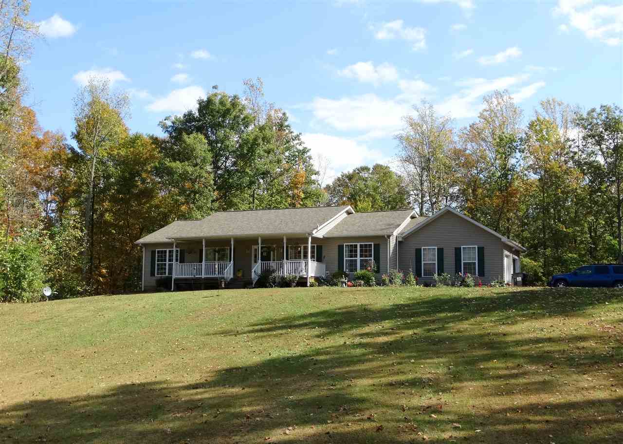 894 Race Ground Road Rochelle, VA 22738 - Photo 17 of 19 a front view of a house with a garden and lake view
