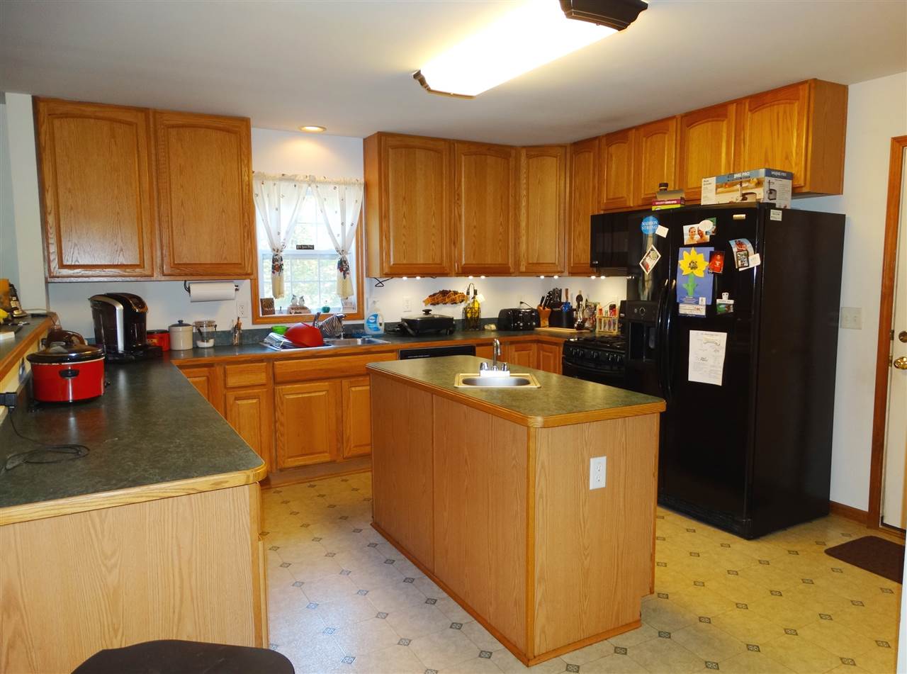 894 Race Ground Road Rochelle, VA 22738 - Photo 8 of 19 a kitchen with sink a refrigerator and cabinets
