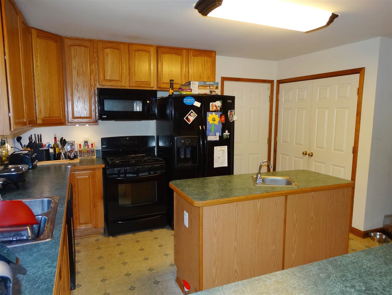 894 Race Ground Road Rochelle, VA 22738 - Photo 9 of 19 a kitchen with stainless steel appliances granite countertop a sink stove and refrigerator