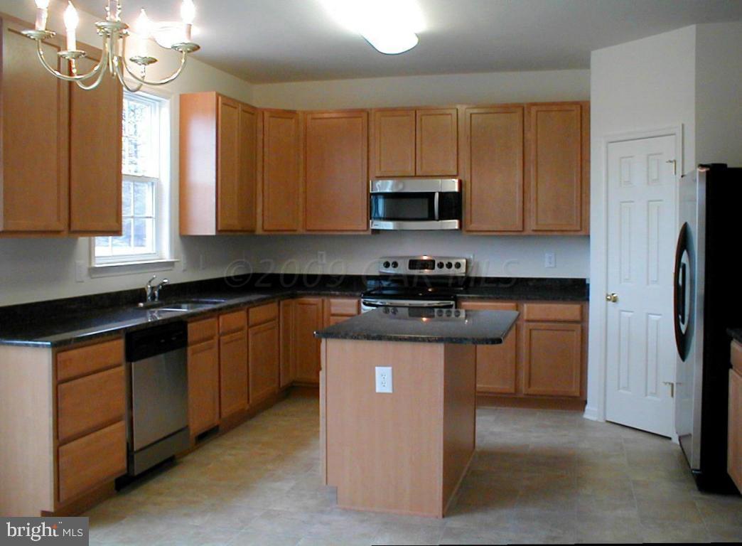 9111 Morgan's Ridge Delmar, MD 21875 - Photo 4 of 7 a kitchen with stainless steel appliances granite countertop a stove a sink dishwasher a refrigerator and a microwave oven