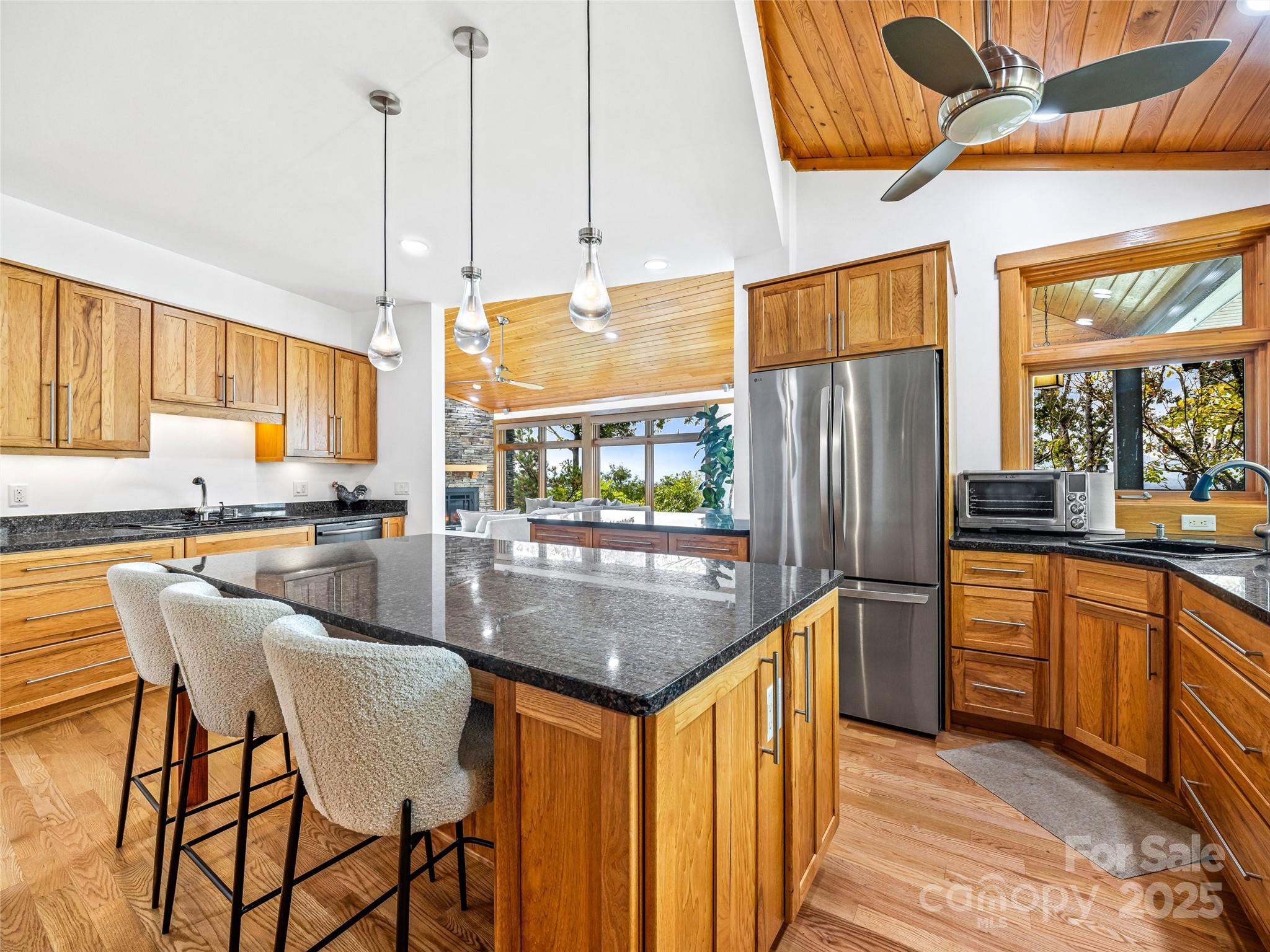 136 Senator Reynolds Road Asheville, NC 28804 - Photo 22 of 48 a kitchen with stainless steel appliances granite countertop a stove top oven a refrigerator a sink and a dining table with chairs