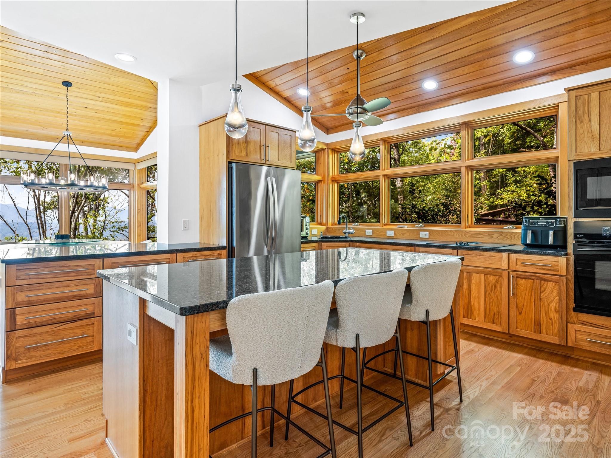 136 Senator Reynolds Road Asheville, NC 28804 - Photo 23 of 48 a view of a dining room with furniture a chandelier and wooden floor