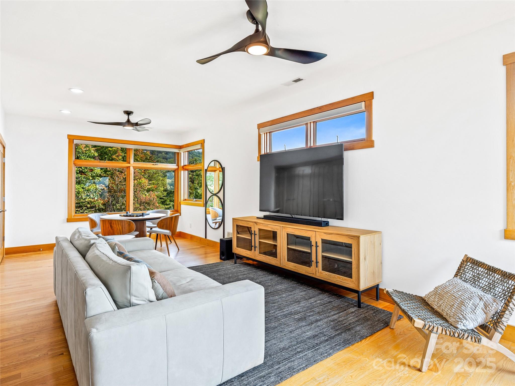 136 Senator Reynolds Road Asheville, NC 28804 - Photo 36 of 48 a living room with furniture and a flat screen tv