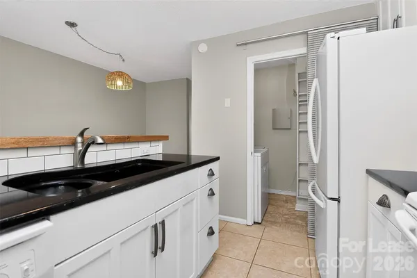 a kitchen with a sink and a refrigerator