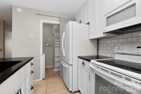a kitchen with a refrigerator and a sink