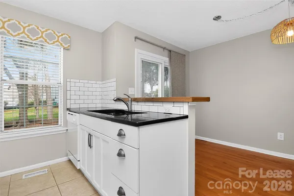 a kitchen with granite countertop a sink and a stove
