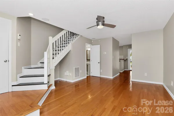 a view of entryway and hall with wooden floor