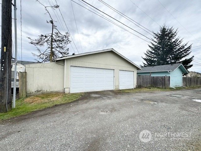 a view of a house with a yard and garage