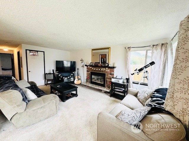 a living room with furniture and a flat screen tv with wooden floor