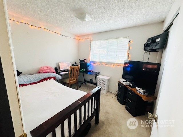 a bedroom with furniture and a window