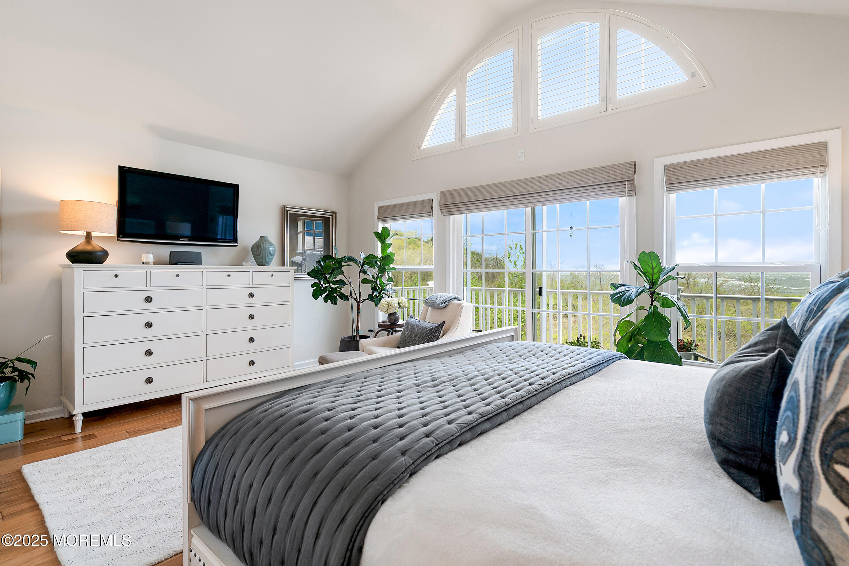 19 Lighthouse Point Road, Unit 504 Highlands, NJ 07732 - Photo 15 of 43 a bedroom with a bed a flat screen tv and a couch
