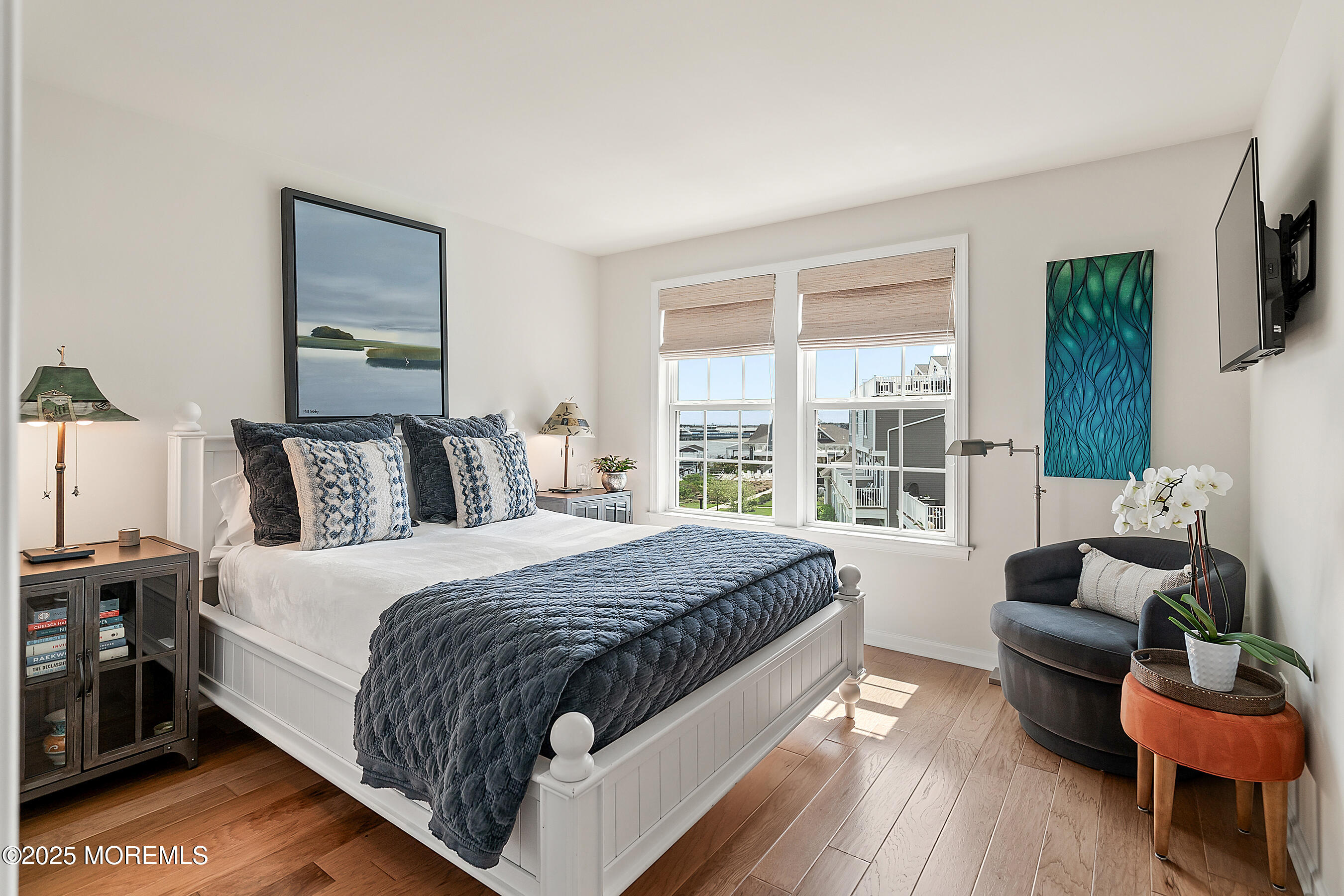 19 Lighthouse Point Road, Unit 504 Highlands, NJ 07732 - Photo 22 of 43 a large bedroom with a bed and wooden floor