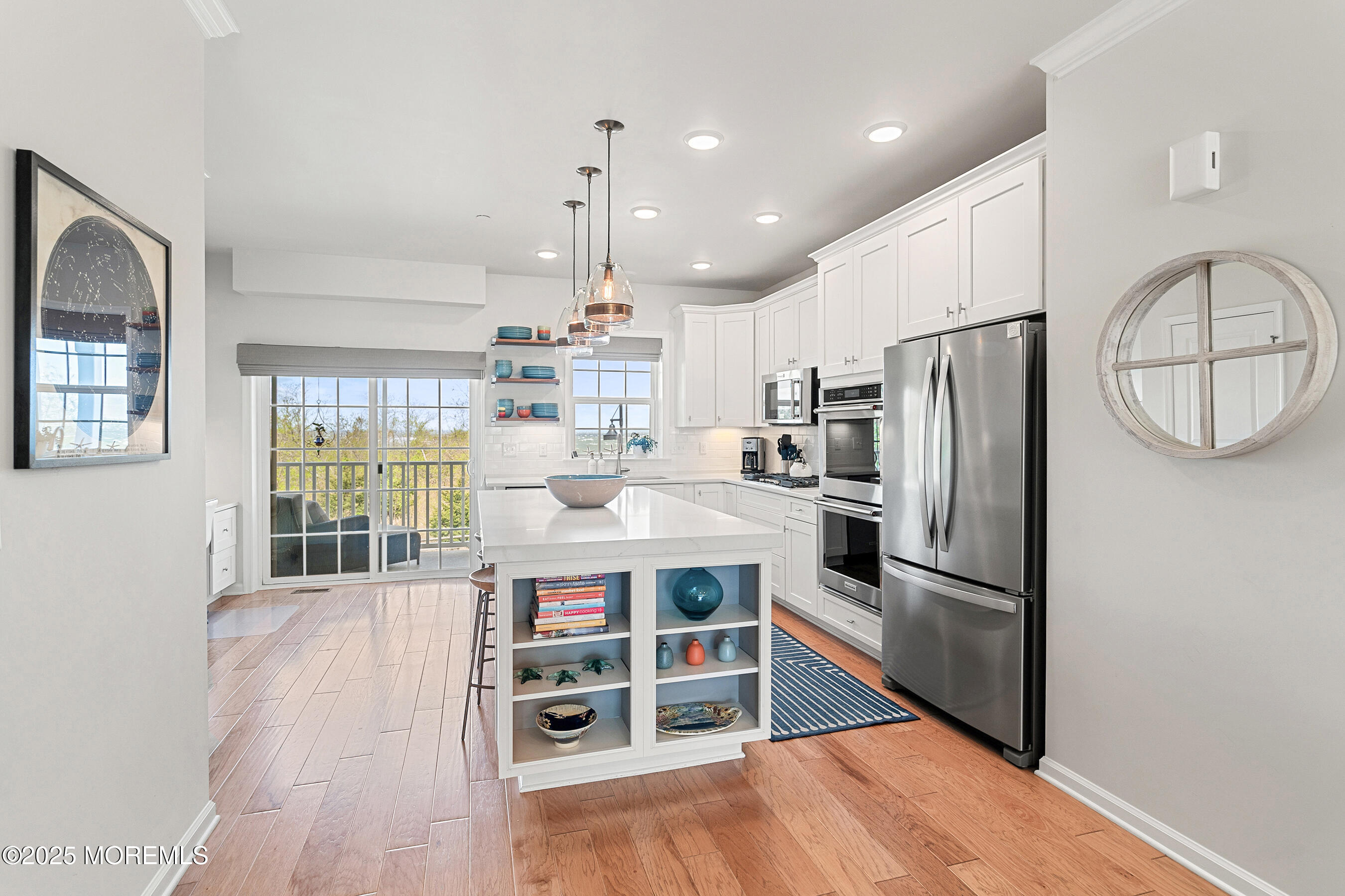 19 Lighthouse Point Road, Unit 504 Highlands, NJ 07732 - Photo 3 of 43 a kitchen with stainless steel appliances a refrigerator a stove a sink cabinets and wooden floor