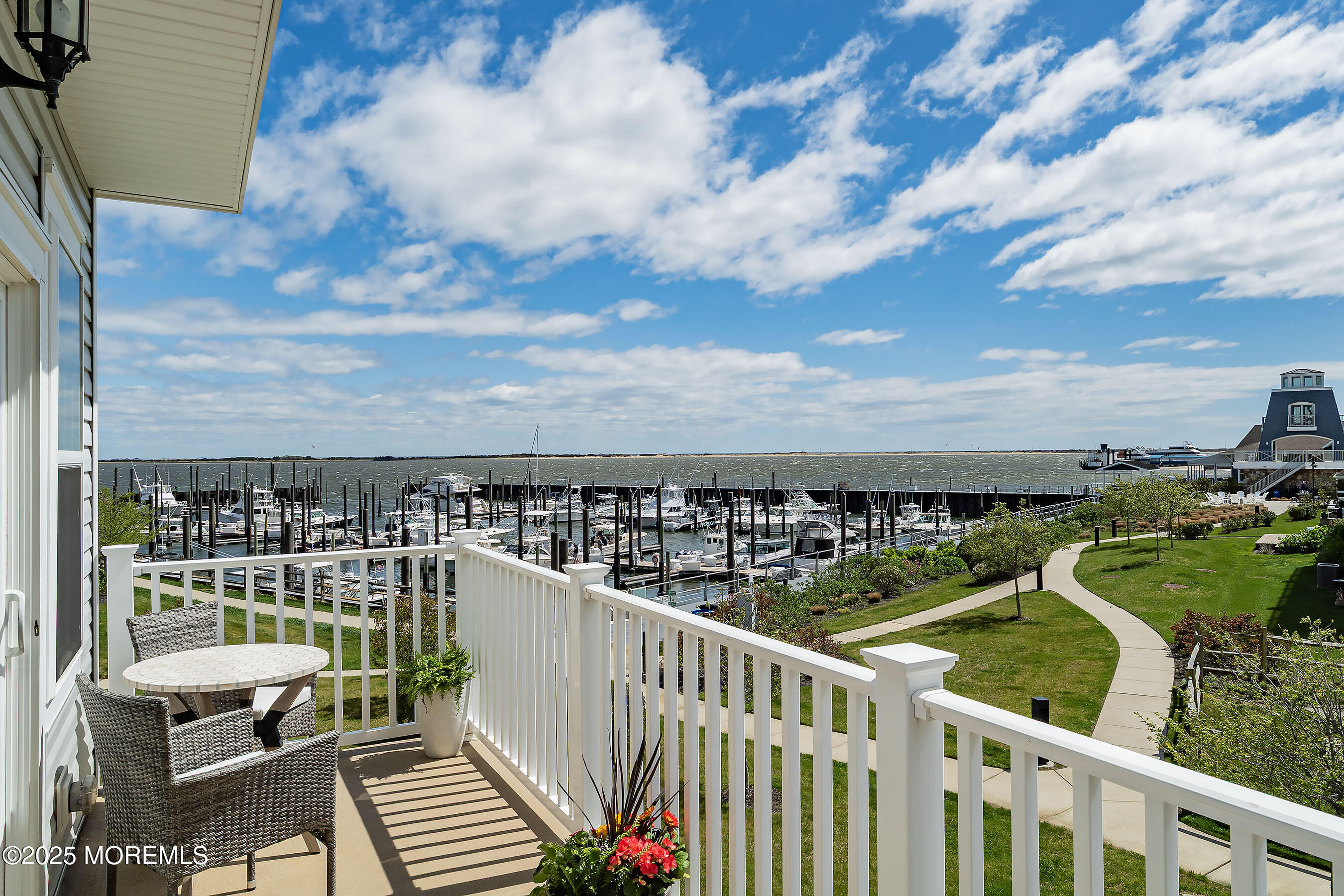19 Lighthouse Point Road, Unit 504 Highlands, NJ 07732 - Photo 9 of 43 a view of a balcony with wooden chairs and city view