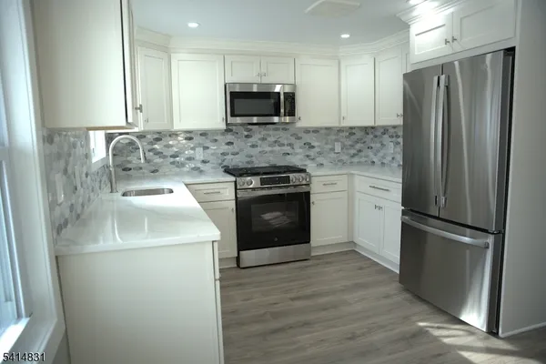 a kitchen with a refrigerator sink and microwave