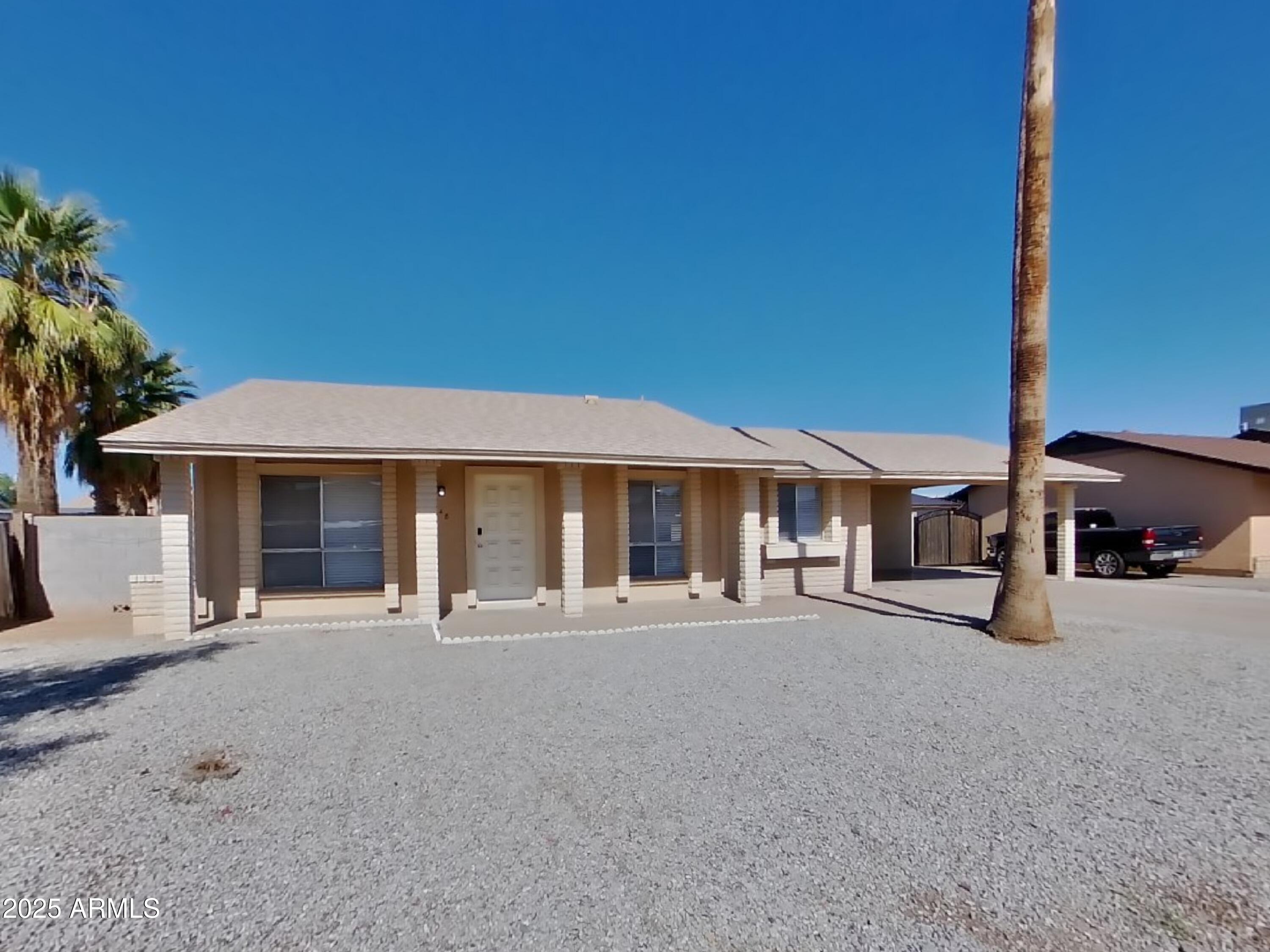 8948 West Heatherbrae Drive Phoenix, AZ 85037 - Photo 1 of 21 a front view of a house with basket ball court and a garage