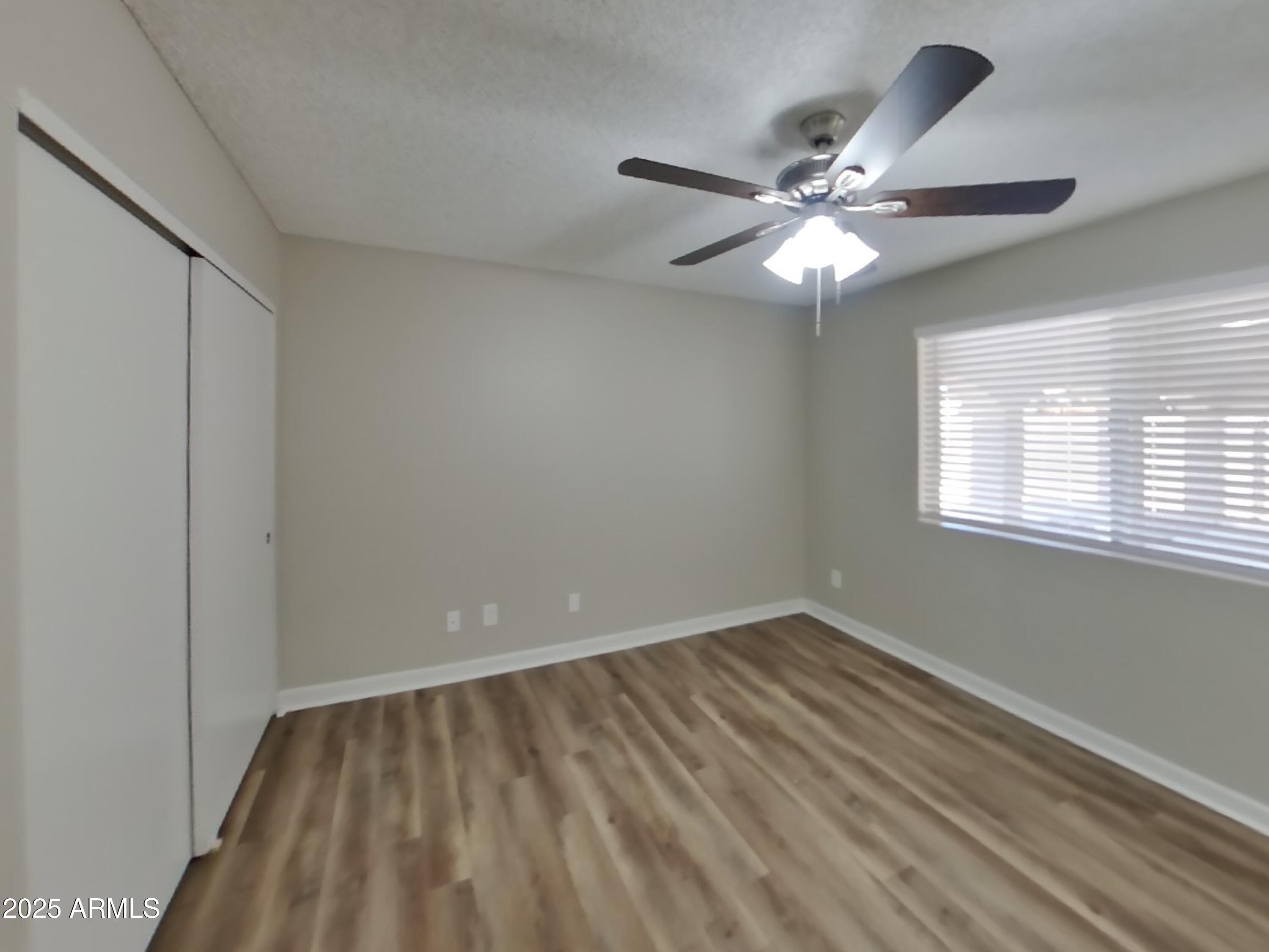 8948 West Heatherbrae Drive Phoenix, AZ 85037 - Photo 11 of 21 a view of an empty room with a window
