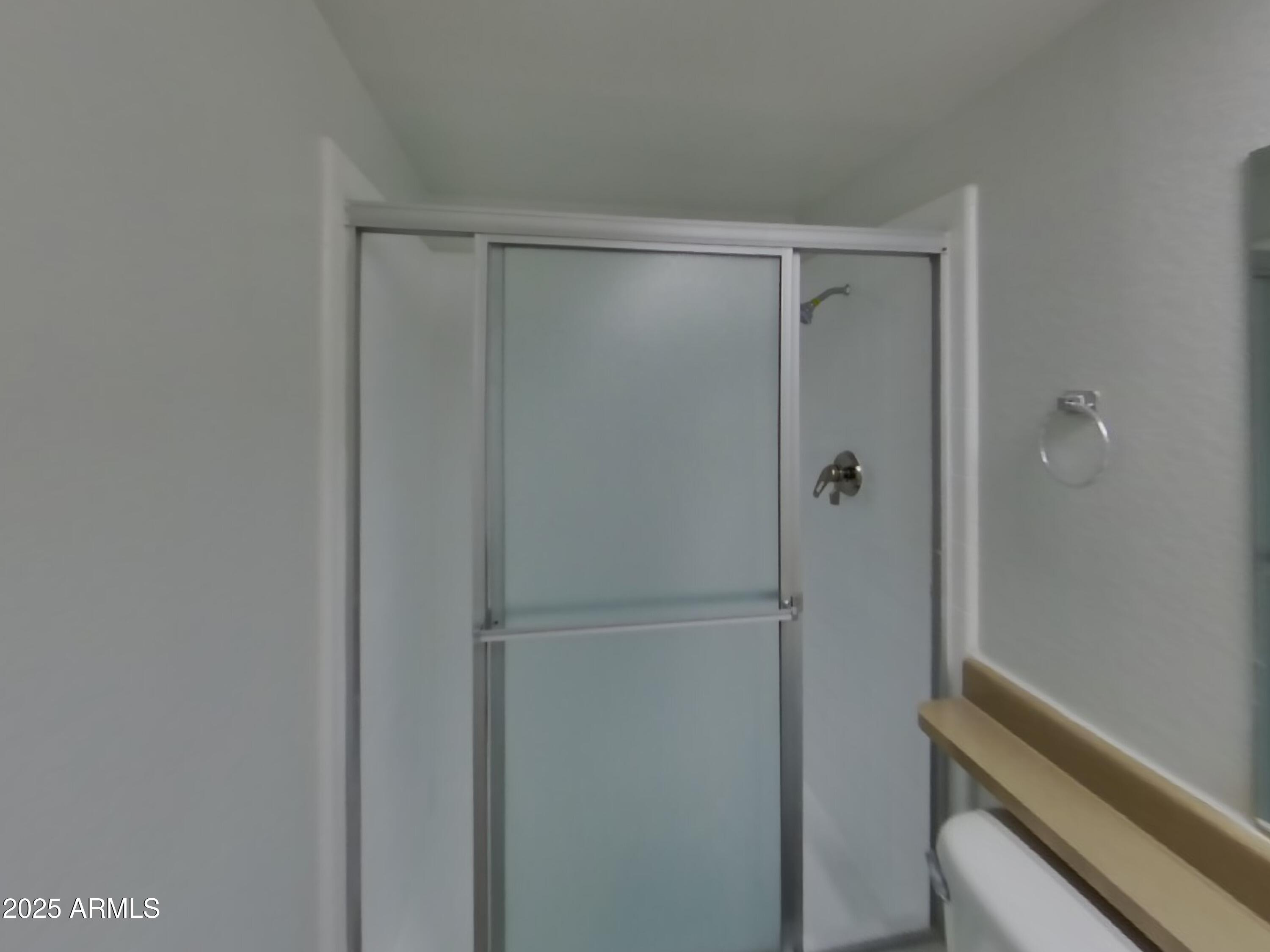 8948 West Heatherbrae Drive Phoenix, AZ 85037 - Photo 13 of 21 a bathroom with a glass shower door