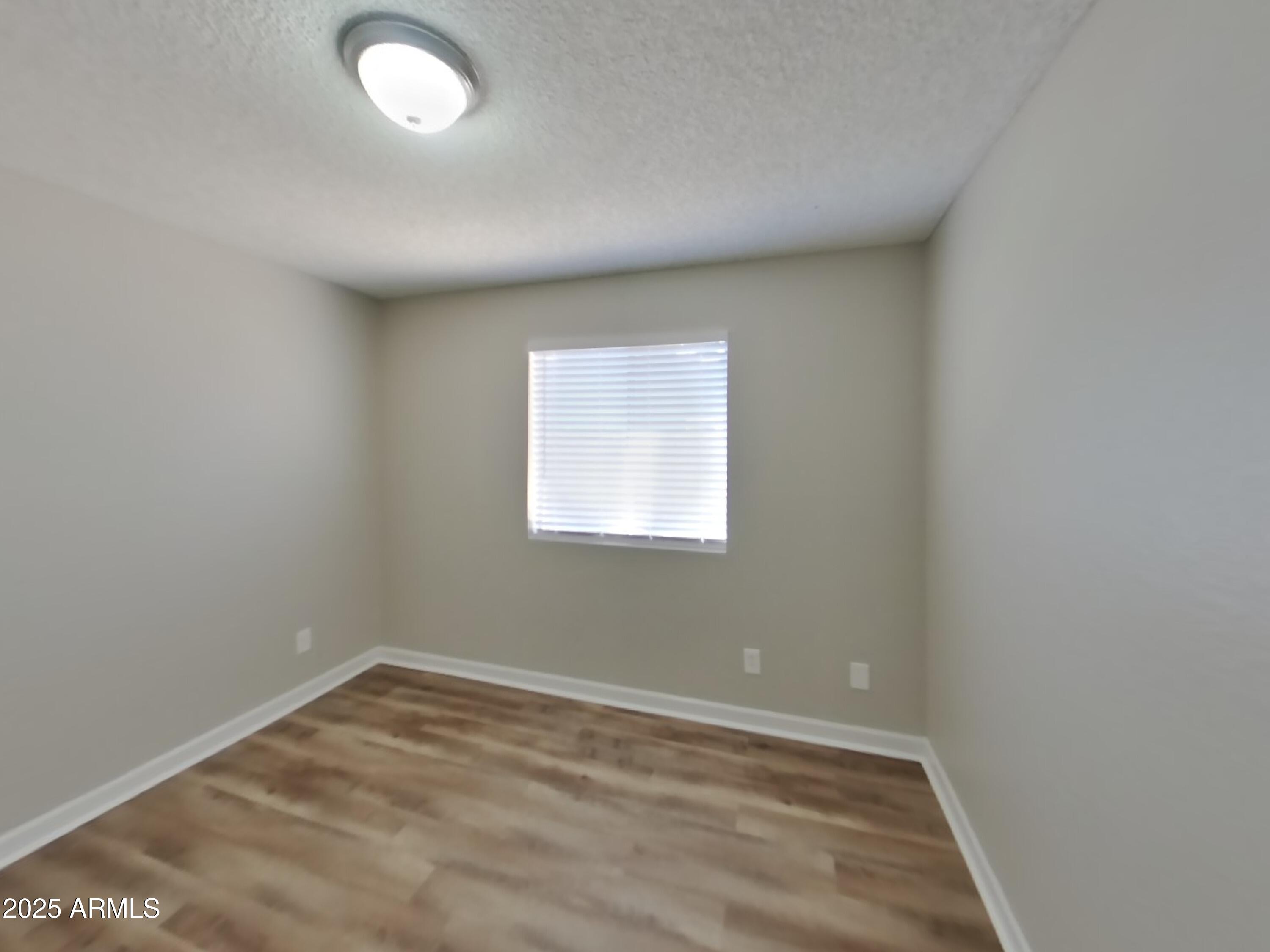 8948 West Heatherbrae Drive Phoenix, AZ 85037 - Photo 14 of 21 an empty room with a window