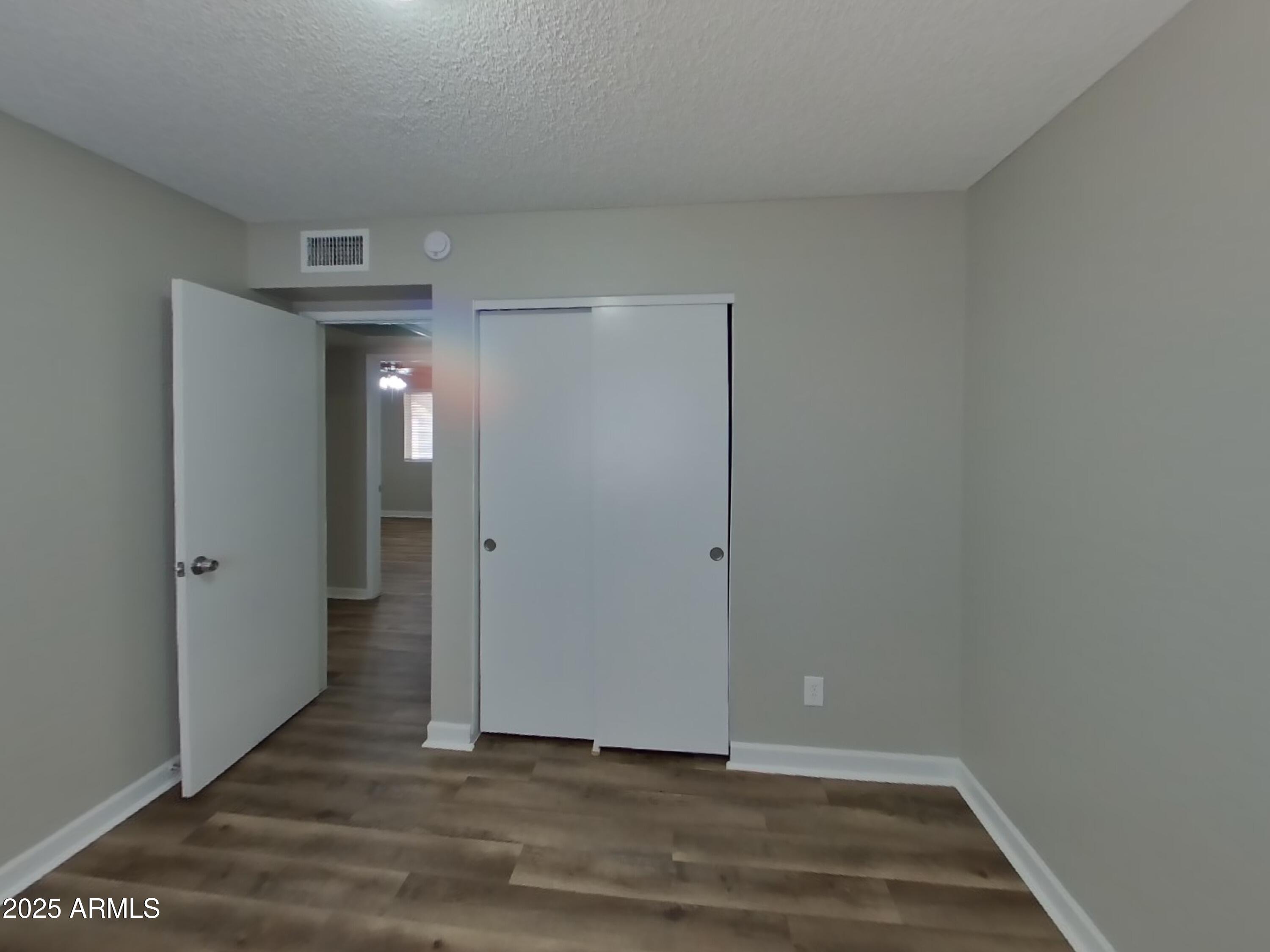 8948 West Heatherbrae Drive Phoenix, AZ 85037 - Photo 15 of 21 a view of hallway with wooden floor