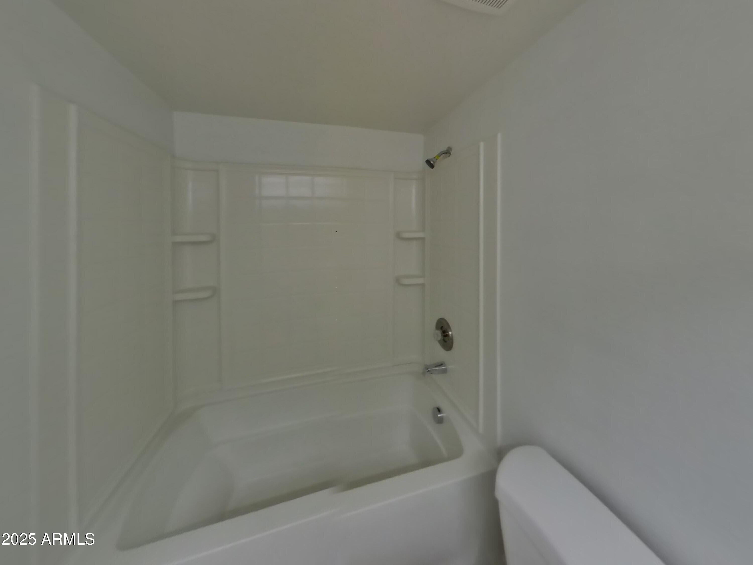 8948 West Heatherbrae Drive Phoenix, AZ 85037 - Photo 19 of 21 a bathroom with a bathtub and toilet
