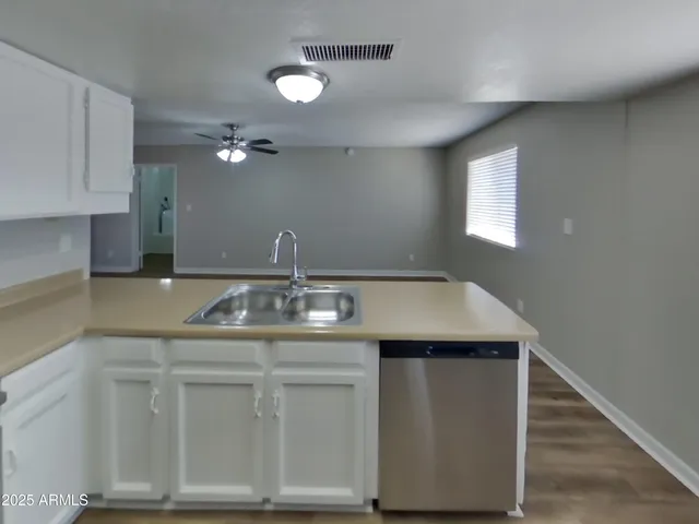 a kitchen with stainless steel appliances a sink stove and cabinets