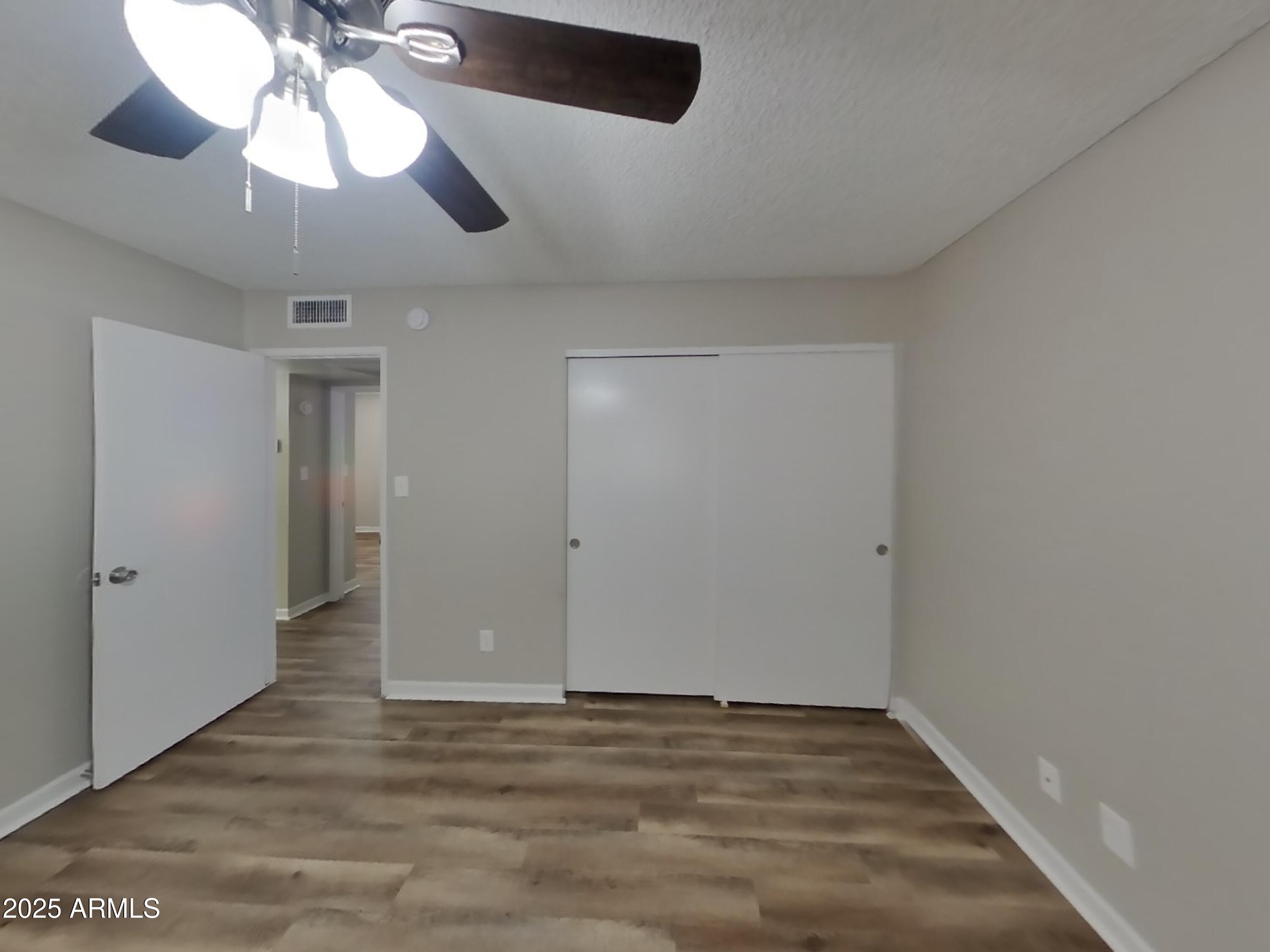 8948 West Heatherbrae Drive Phoenix, AZ 85037 - Photo 9 of 21 a view of an empty room and chandelier fan