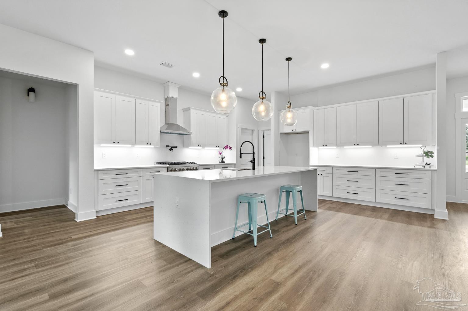 953 Grindstone Lane Cantonment, FL 32533 - Photo 15 of 59 a kitchen with kitchen island white cabinets and stainless steel appliances