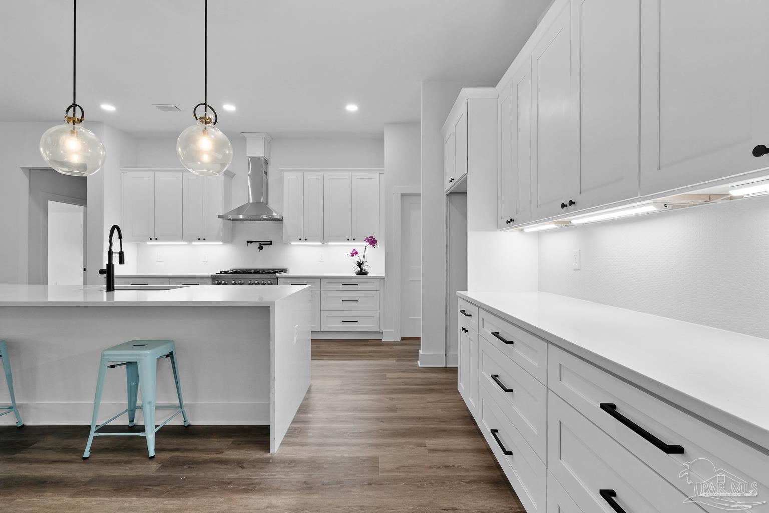 953 Grindstone Lane Cantonment, FL 32533 - Photo 20 of 59 a kitchen with kitchen island white cabinets and stainless steel appliances