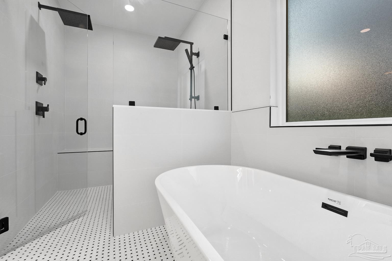 953 Grindstone Lane Cantonment, FL 32533 - Photo 32 of 59 a bathroom with a bathtub and a shower