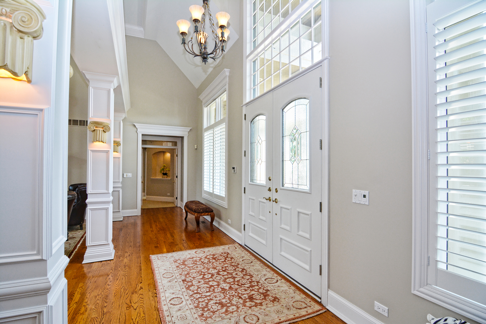 36W580 Stoneleat Road St. Charles, IL 60175 - Photo 4 of 48 a view of a hallway with wooden floor and a chandelier
