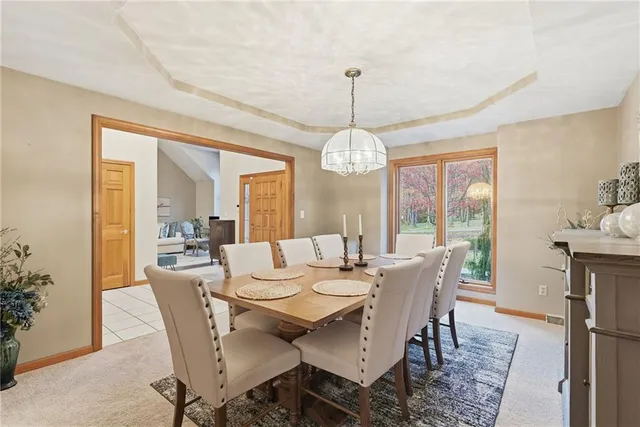 a view of a dining room with furniture wooden floor and chandelier