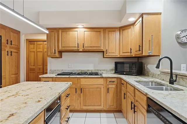 a kitchen with stainless steel appliances granite countertop a sink and cabinets