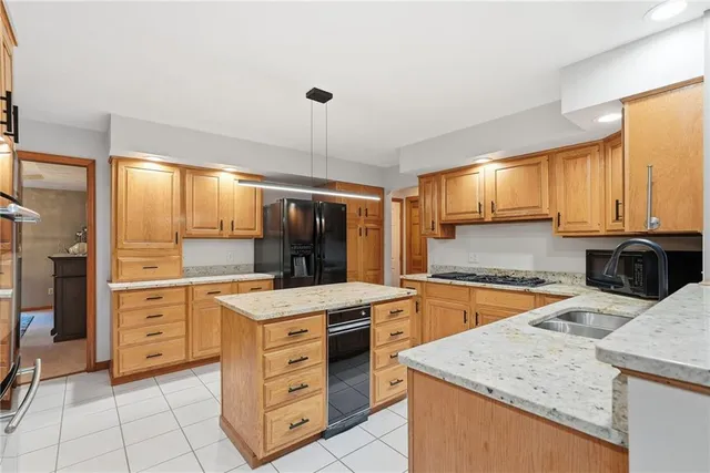 a kitchen with a stove a sink and a refrigerator
