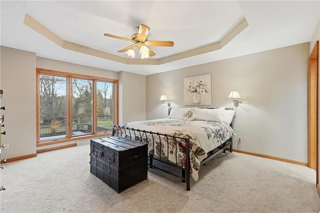a spacious bedroom with a bed and ceiling fan