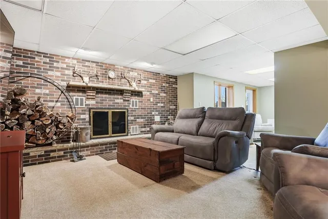 a living room with furniture a fireplace and a potted plant