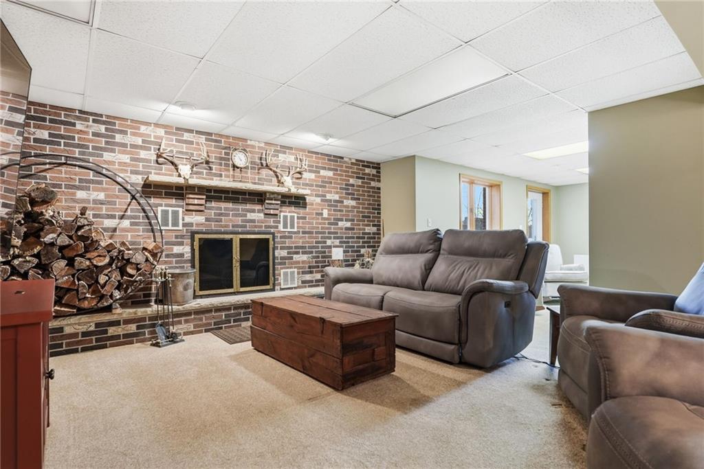 152 Timber Springs Drive Indiana, PA 15701 - Photo 32 of 49 a living room with furniture a fireplace and a potted plant