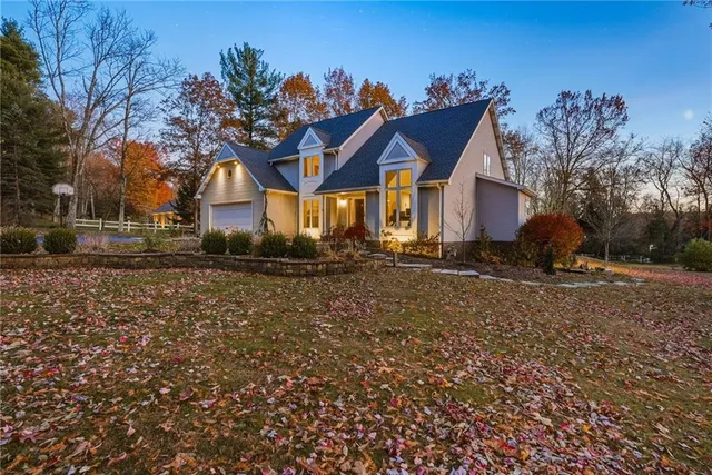 a view of a house with a small yard next to a road