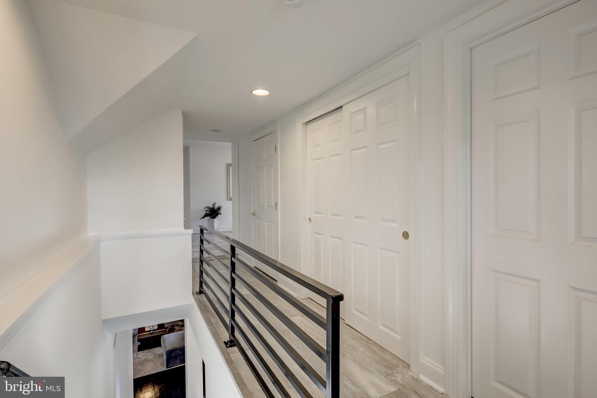 8040 Leishear Road Laurel, MD 20723 - Photo 48 of 66 Transition to upper level, LVP, dark iron railing.