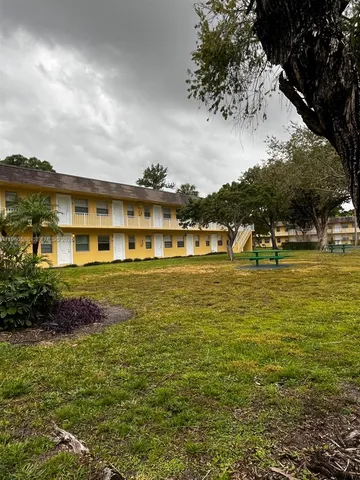 a view of a large building with a garden