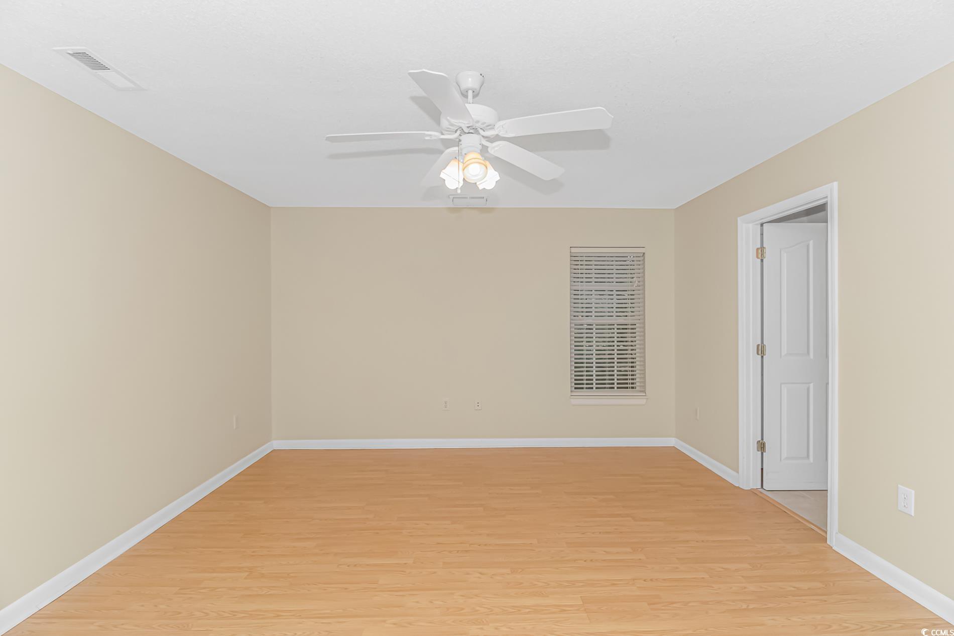 4243 Horseshoe Road North Little River, SC 29566 - Photo 12 of 26 Spare room with light wood-type flooring and ceili