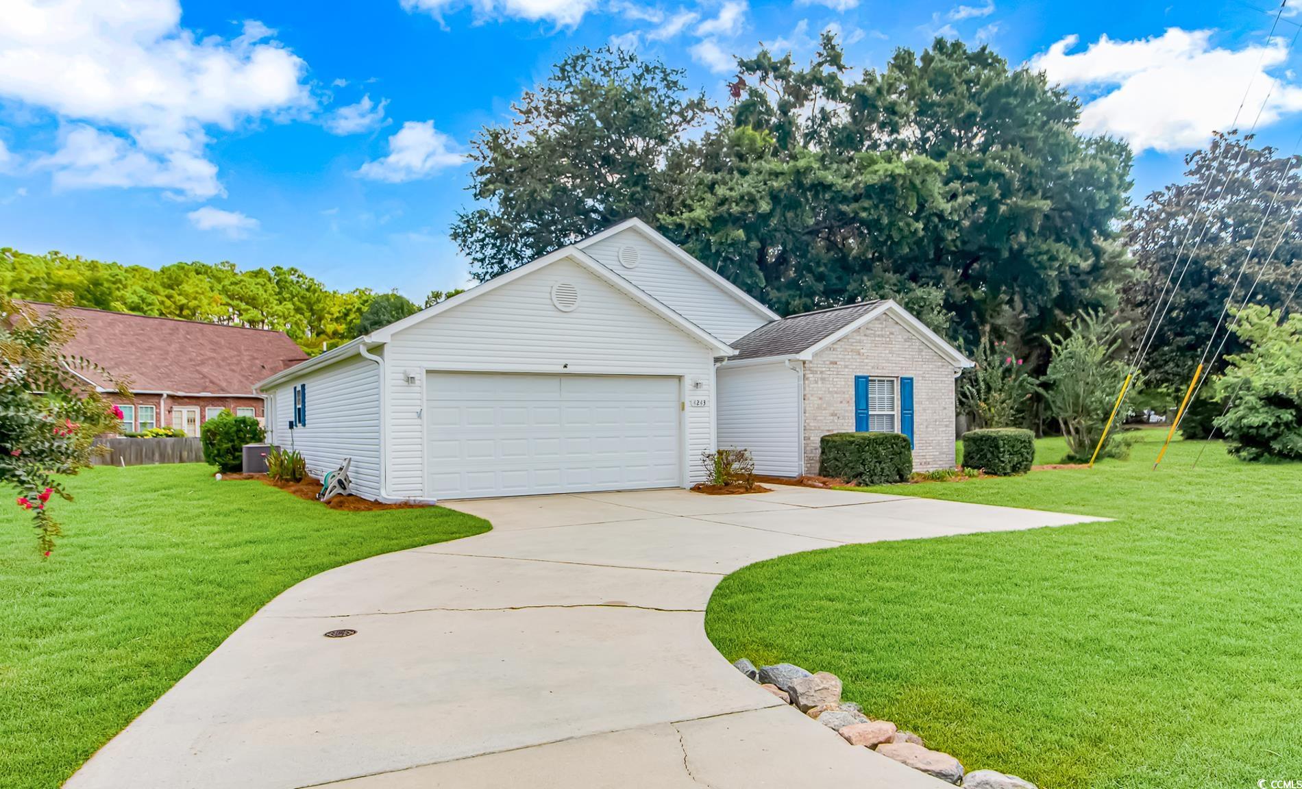 4243 Horseshoe Road North Little River, SC 29566 - Photo 2 of 26 Ranch-style house featuring a garage and a front y