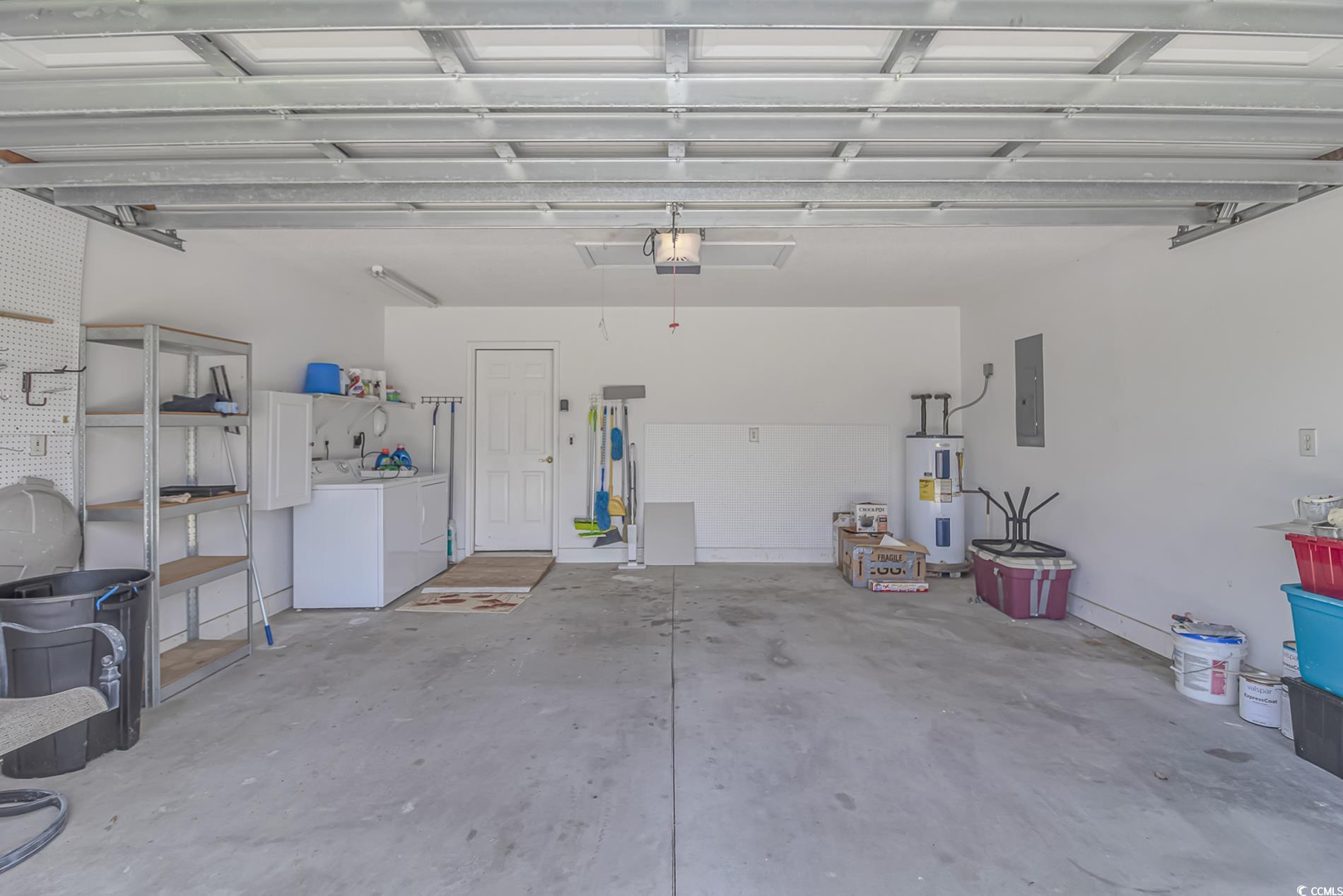 4243 Horseshoe Road North Little River, SC 29566 - Photo 23 of 26 Garage featuring electric water heater, a garage d