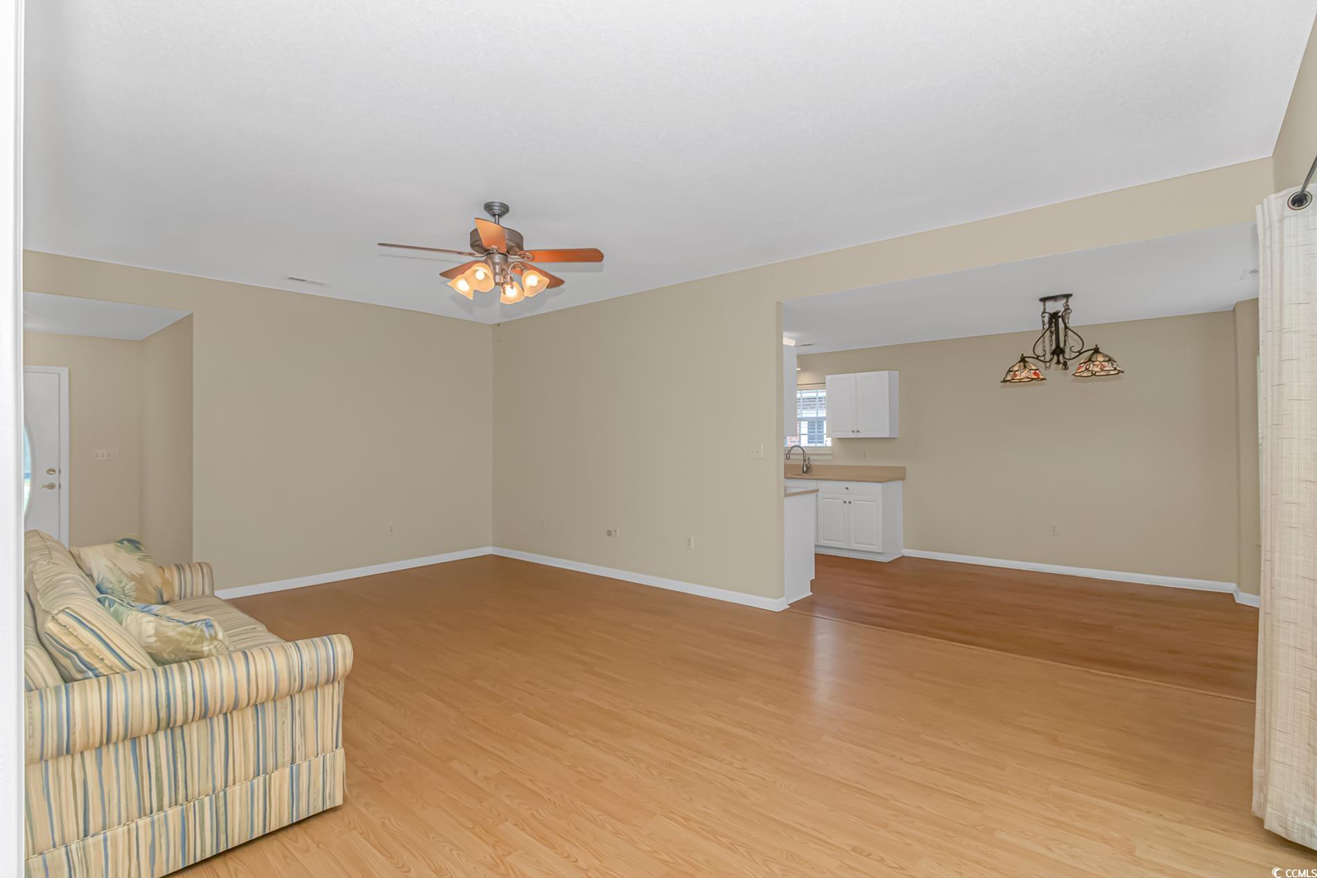 4243 Horseshoe Road North Little River, SC 29566 - Photo 6 of 26 Unfurnished living room featuring ceiling fan and
