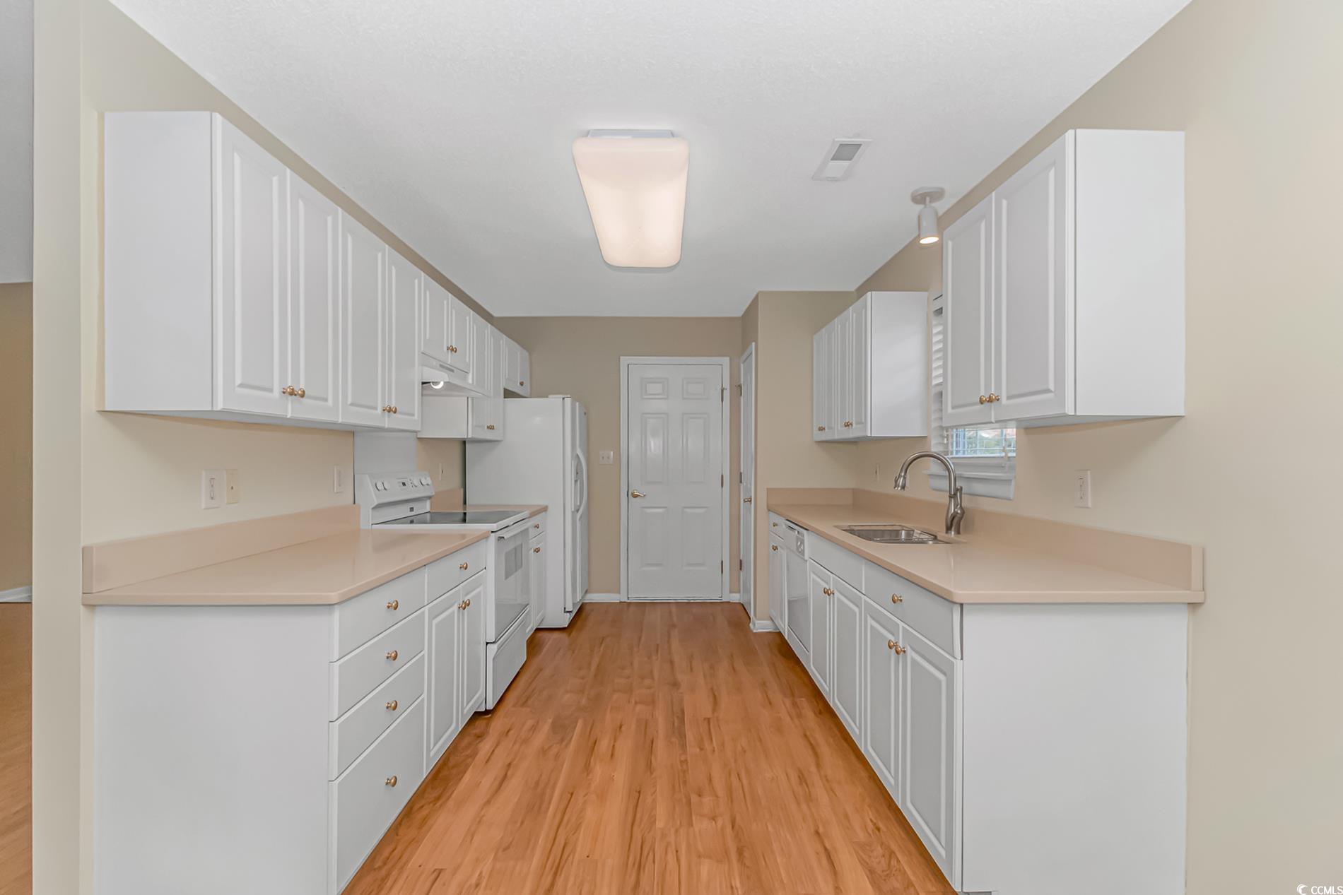 4243 Horseshoe Road North Little River, SC 29566 - Photo 8 of 26 Kitchen with white cabinetry, white appliances, li