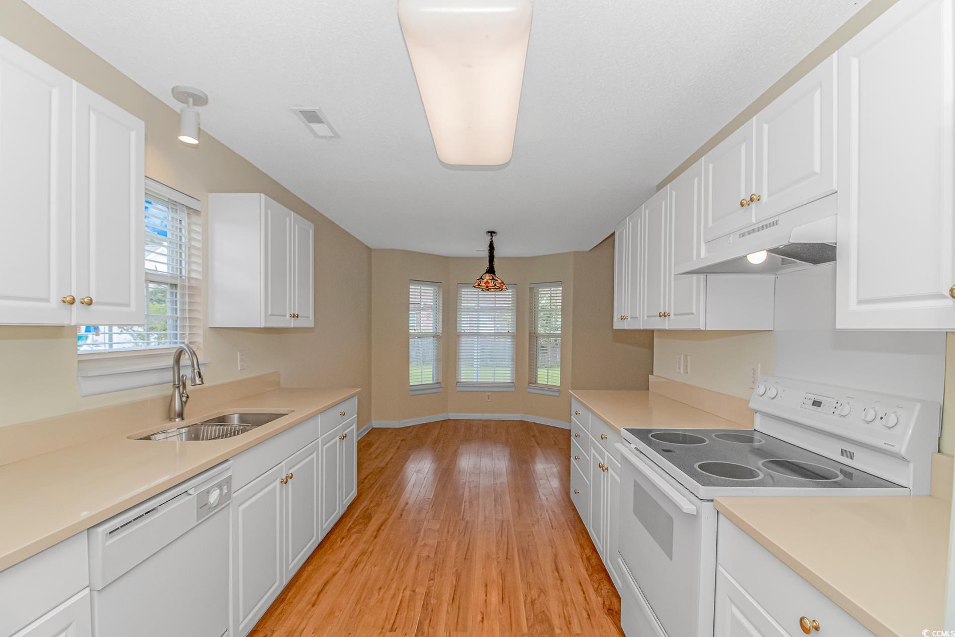 4243 Horseshoe Road North Little River, SC 29566 - Photo 9 of 26 Kitchen with decorative light fixtures, white appl