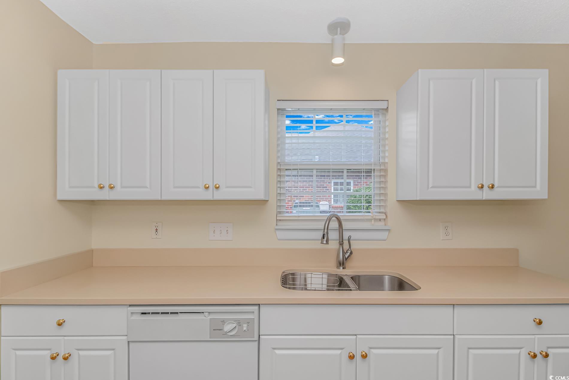 4243 Horseshoe Road North Little River, SC 29566 - Photo 10 of 26 Kitchen featuring white cabinets, white dishwasher