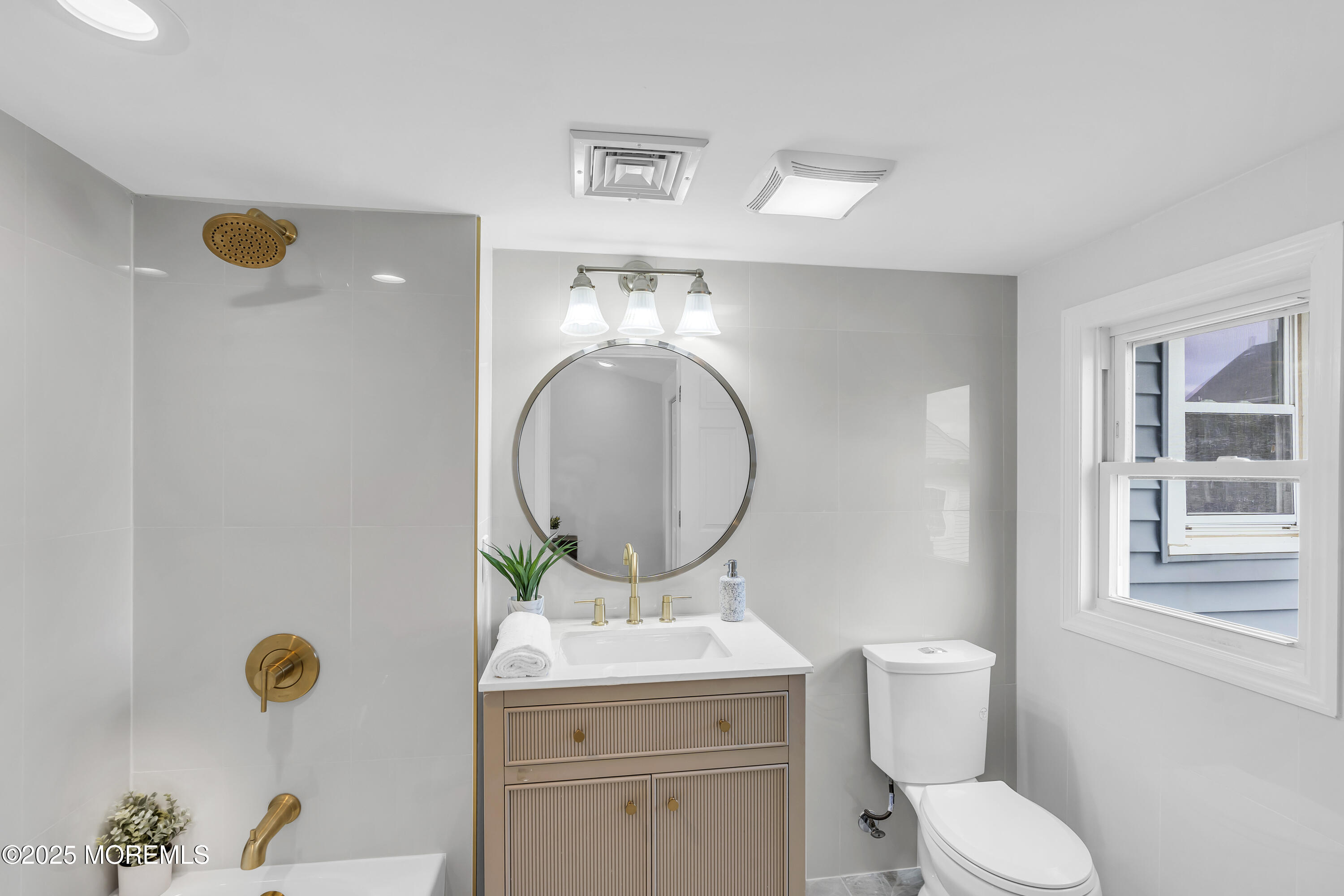 825 Lorillard Avenue Union Beach, NJ 07735 - Photo 11 of 22 a bathroom with a toilet mirror vanity and a sink