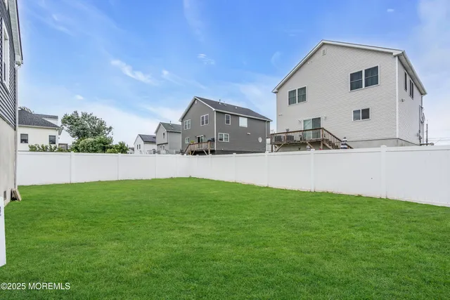 a view of a house with backyard and a tree